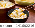 Corn rice, a summer mixed rice dish served in a wooden rice container and a bowl. 141602216