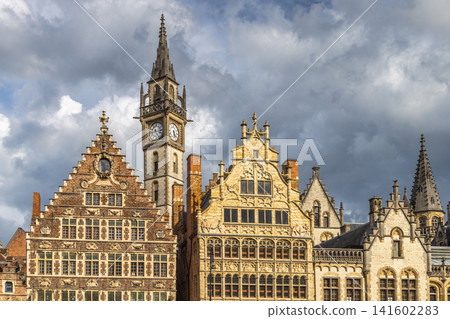 Ghent town in Belgium, Europe. Historic European Architecture Under a Dramatic Sky: Detailed Facades of Ancient Buildings and a Grand Clock Tower Ghent town in Belgium, Europe. Historic European Architecture Under a Dramatic Sky: Detailed Facades of Ancient Buildings and a Grand Clock Tower 141602283