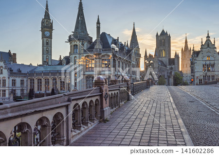 Ghent town in Belgium, Europe. View from Historic St. Michael's Bridge. Ancient Cityscape at Dawn with Cobblestone Street and Historic Architecture under a Clear Sky Ghent town in Belgium, Europe. View from Historic St. Michael's Bridge. Ancient Cityscape at Dawn with Cobblestone Street and Historic Architecture under a Clear Sky 141602286