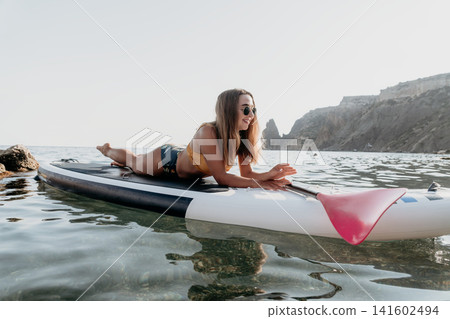 Woman Paddleboarding Ocean Summer Beach Relaxing Woman Paddleboarding Ocean Summer Beach Relaxing 141602494