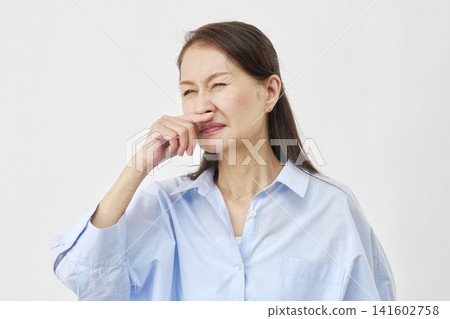 Woman with stuffy nose on white background Woman with stuffy nose on white background 141602758