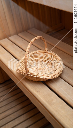Empty wicker basket on wooden sauna bench interior design 141603654
