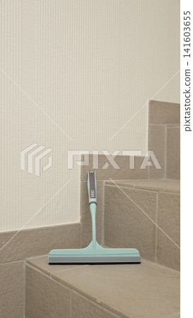 Aqua squeegee on tiled staircase corner for efficient home cleaning Aqua squeegee on tiled staircase corner for efficient home cleaning 141603655