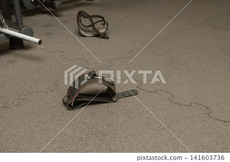 Worn weightlifting wrist wraps on gym floor Worn weightlifting wrist wraps on gym floor 141603736