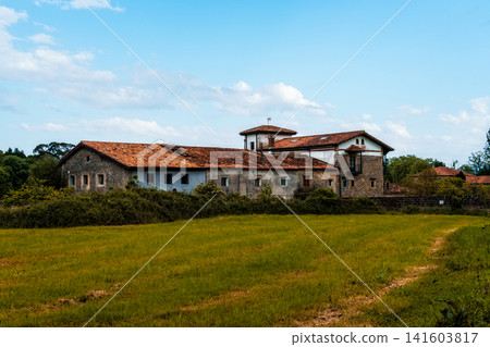 Picturesque view of a traditional Spanish farmhouse under a bright blue sky Picturesque view of a traditional Spanish farmhouse under a bright blue sky 141603817