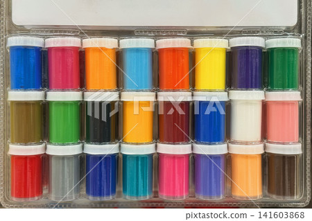 Paint pots set. Set of paint pots in plastic tray, multiple colors for school, craft, classroom use. Concept of paint collection, art supplies, color palette, drawing, painting, education background Paint pots set. Set of paint pots in plastic tray, multiple colors for school, craft, classroom use. Concept of paint collection, art supplies, color palette, drawing, painting, education background 141603868
