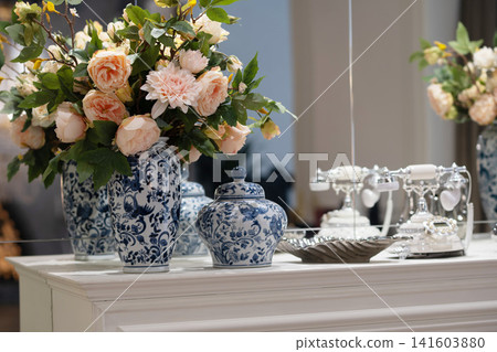 Elegant Peonies in Glass Vases Near Vintage Mirror in Luxury Interior. Elegant Peonies in Glass Vases Near Vintage Mirror in Luxury Interior. 141603880