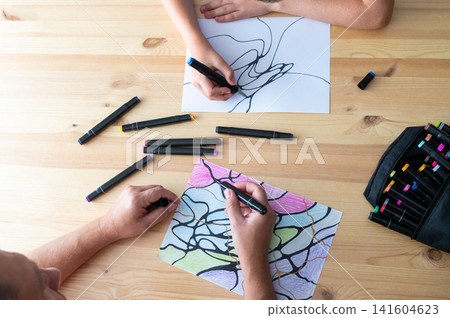 Artistic Hands Engaged in Drawing and Coloring Activities Artistic Hands Engaged in Drawing and Coloring Activities 141604623