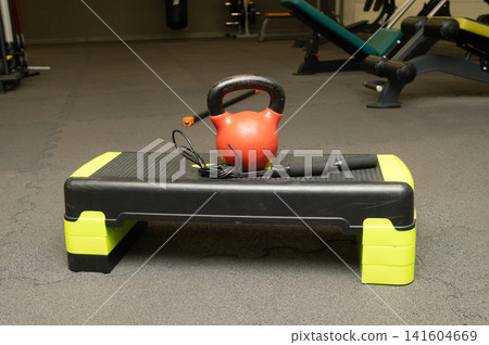 Kettlebell and jump rope on step platform in gym Kettlebell and jump rope on step platform in gym 141604669