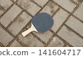 Table tennis paddle on brick surface 141604717