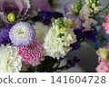 Vibrant bouquet of mixed colorful flowers with soft lighting 141604728