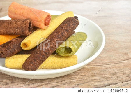 colorful crispy stick biscuit stuffed cream flavour arranging on plate colorful crispy stick biscuit stuffed cream flavour arranging on plate 141604742