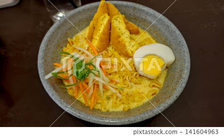 Indonesian Curry Noodle Soup Laksa with Tofu Egg and Shredded Vegetables 141604963