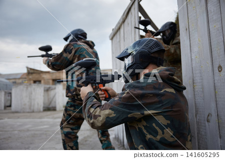 Two soldiers point their guns at a target on a training field Two soldiers point their guns at a target on a training field 141605295