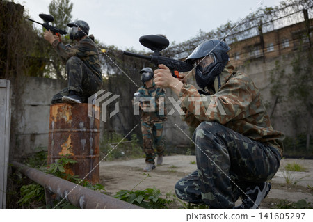 Group of soldiers take defensive positions and preparing for the attack during tactical training Group of soldiers take defensive positions and preparing for the attack during tactical training 141605297