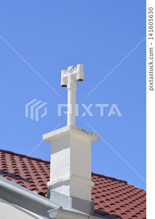 White chimney with a ventilation cowl 141605630
