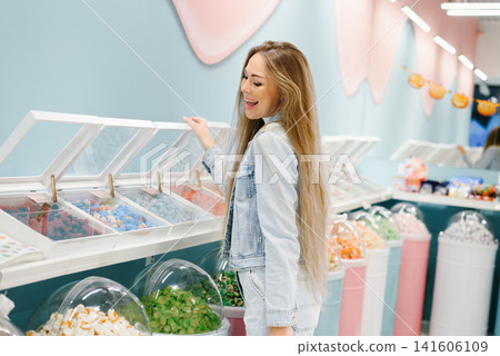 Customer Choosing Sweet Treats in Candy Store Customer Choosing Sweet Treats in Candy Store 141606109