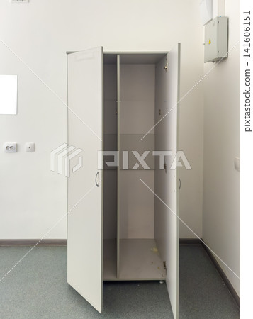 Empty white storage cabinet with open doors in a minimalistic indoor space 141606151