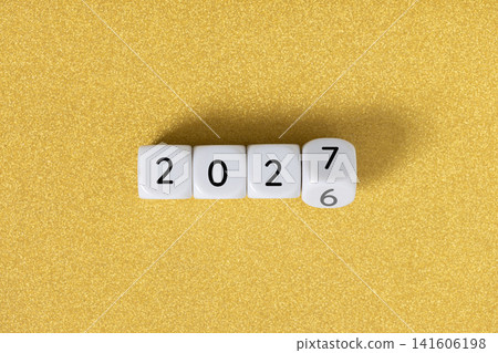 Year 2026 changing to 2027 on dice, glitter festive golden background. New year change concept Year 2026 changing to 2027 on dice, glitter festive golden background. New year change concept 141606198