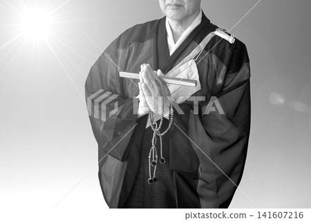Hands of a Buddhist monk clasped in prayer (monochrome image) Hands of a Buddhist monk clasped in prayer (monochrome image) 141607216