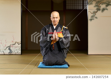 Portrait of a Buddhist priest sitting in a seiza (kneeling) position in a Japanese-style room. Portrait of a Buddhist priest sitting in a seiza (kneeling) position in a Japanese-style room. 141607254
