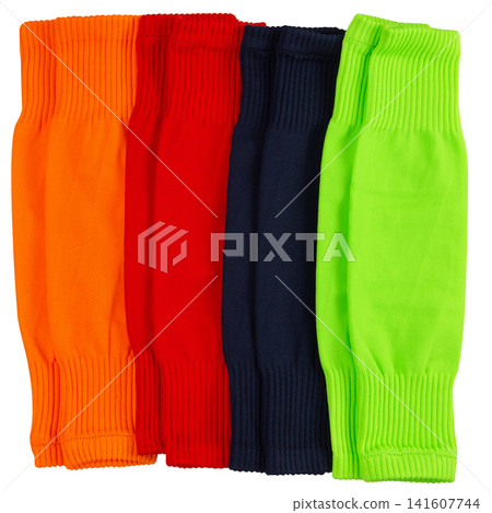 Set of colorful football leg sleeves isolated on white background. Multi-colored soccer calf compression sleeves for shin guard protection Set of colorful football leg sleeves isolated on white background. Multi-colored soccer calf compression sleeves for shin guard protection 141607744