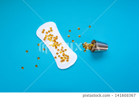 Sanitary Pad with Gold Sequins Pouring from Metal Cup, Heavy Urinary Incontinence Concept Sanitary Pad with Gold Sequins Pouring from Metal Cup, Heavy Urinary Incontinence Concept 141608367