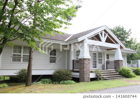 Exterior view of a resort cottage surrounded by nature Exterior view of a resort cottage surrounded by nature 141608744