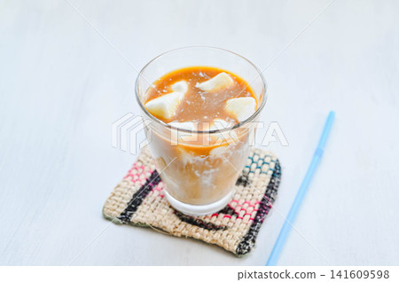Iced café au lait with homemade milk ice. Iced café au lait with homemade milk ice. 141609598