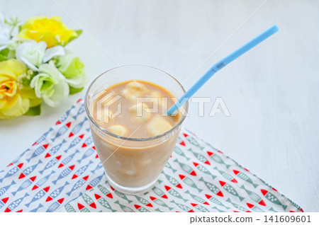 Iced café au lait with homemade milk ice. Iced café au lait with homemade milk ice. 141609601