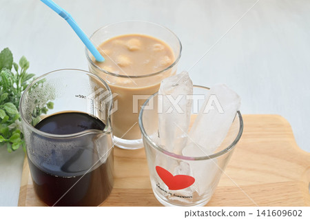 Homemade iced coffee and iced café au lait poured into glasses Homemade iced coffee and iced café au lait poured into glasses 141609602