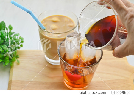 Making a cold iced coffee and a café au lait Making a cold iced coffee and a café au lait 141609603
