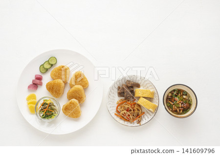 Grilled rice ball and Japanese side dish breakfast set, white background, overhead view. Grilled rice ball and Japanese side dish breakfast set, white background, overhead view. 141609796