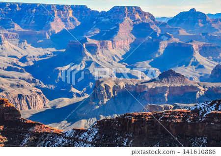 On a clear winter morning, from Mather Point in Grand Canyon National Park, the canyon is bathed in the morning sun, creating a breathtaking, three-dimensional view. 141610886