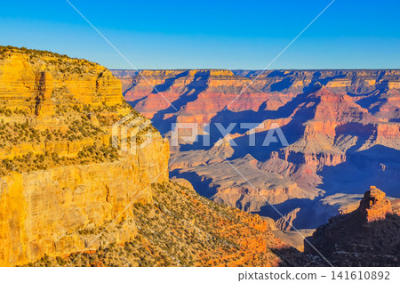 On a clear winter morning, from Mather Point in Grand Canyon National Park, the canyon is bathed in the morning sun, creating a breathtaking, three-dimensional view. On a clear winter morning, from Mather Point in Grand Canyon National Park, the canyon is bathed in the morning sun, creating a breathtaking, three-dimensional view. 141610892