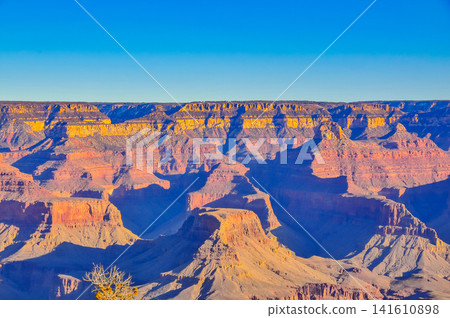 On a clear winter morning, from Mather Point in Grand Canyon National Park, the canyon is bathed in the morning sun, creating a breathtaking, three-dimensional view. On a clear winter morning, from Mather Point in Grand Canyon National Park, the canyon is bathed in the morning sun, creating a breathtaking, three-dimensional view. 141610898