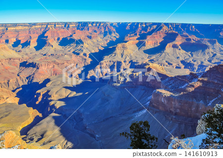 On a clear winter morning, from Mather Point in Grand Canyon National Park, the canyon is bathed in the morning sun, creating a breathtaking, three-dimensional view. On a clear winter morning, from Mather Point in Grand Canyon National Park, the canyon is bathed in the morning sun, creating a breathtaking, three-dimensional view. 141610913