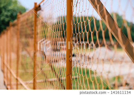 [#ConstructionSite] Close-up of a construction site lined with orange fences 141611134
