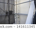 Exterior wall renovation work that shows the old and new siding. 141611345
