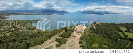 Drone panorama of Rocca di Manerba, San Biagio Island and Lake Garda in summer Drone panorama of Rocca di Manerba, San Biagio Island and Lake Garda in summer 141611721