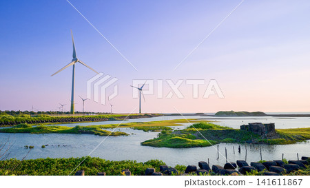 Wind turbines spinning over coastal wetlands in Yuanli, Miaoli, Taiwan. Wind turbines spinning over coastal wetlands in Yuanli, Miaoli, Taiwan. 141611867