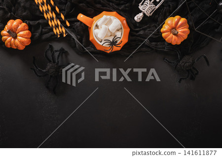 Halloween flat lay with pumpkin mug marshmallows spiders and copy space Halloween flat lay with pumpkin mug marshmallows spiders and copy space 141611877