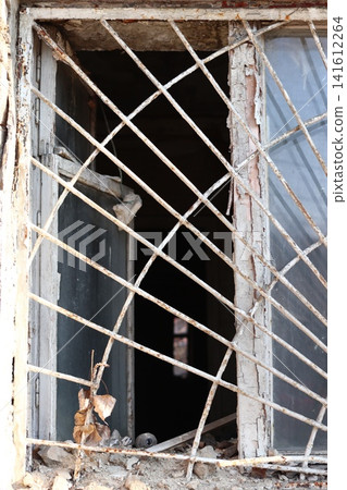 A grate and a broken window pane. A grate and a broken window pane. 141612264