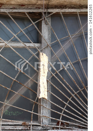 A grate and a broken window pane. A grate and a broken window pane. 141612265