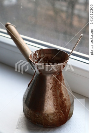 A Traditional Copper Coffee Pot with Spattered Grounds. A Traditional Copper Coffee Pot with Spattered Grounds. 141612306