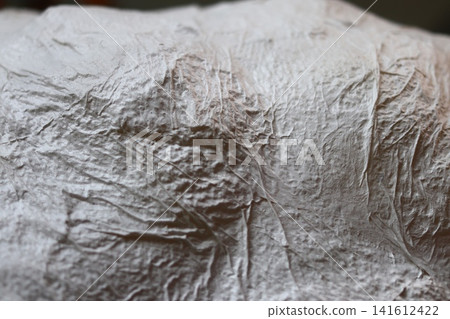 A fragment of a papier-mache cloud. A fragment of a papier-mache cloud. 141612422