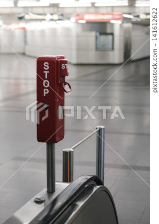 Emergency stop button on an escalator in a subway station illustrating the technical reliability of safety equipment. Emergency stop button on an escalator in a subway station illustrating the technical reliability of safety equipment. 141612622