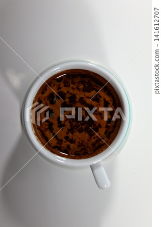 Top-down view of one cup of black coffee. Top-down view of one cup of black coffee. 141612707