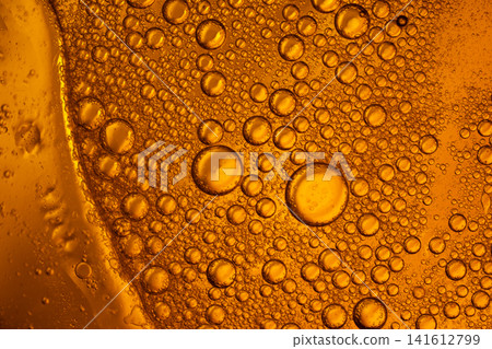 Golden liquid forming abstract oil bubbles texture as a macro background Golden liquid forming abstract oil bubbles texture as a macro background 141612799