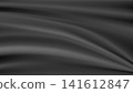 Black silk flowing fabric creating elegant abstract background 141612847